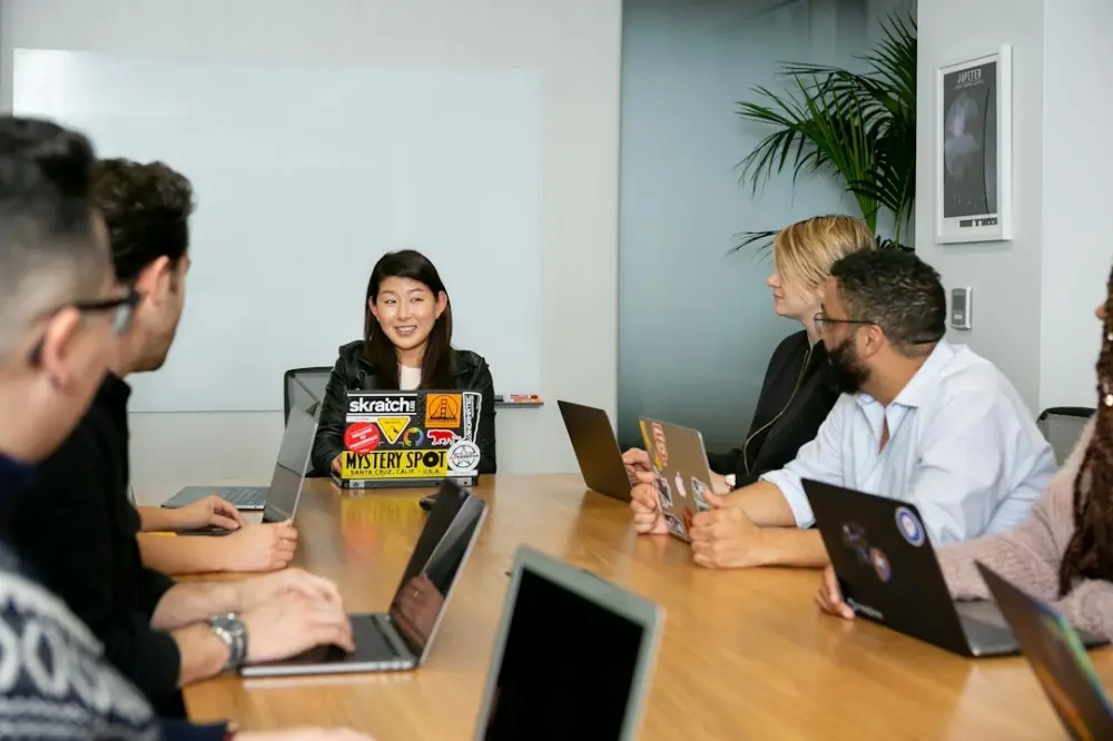 People in a meeting discussing app development, illustrating ILM courses